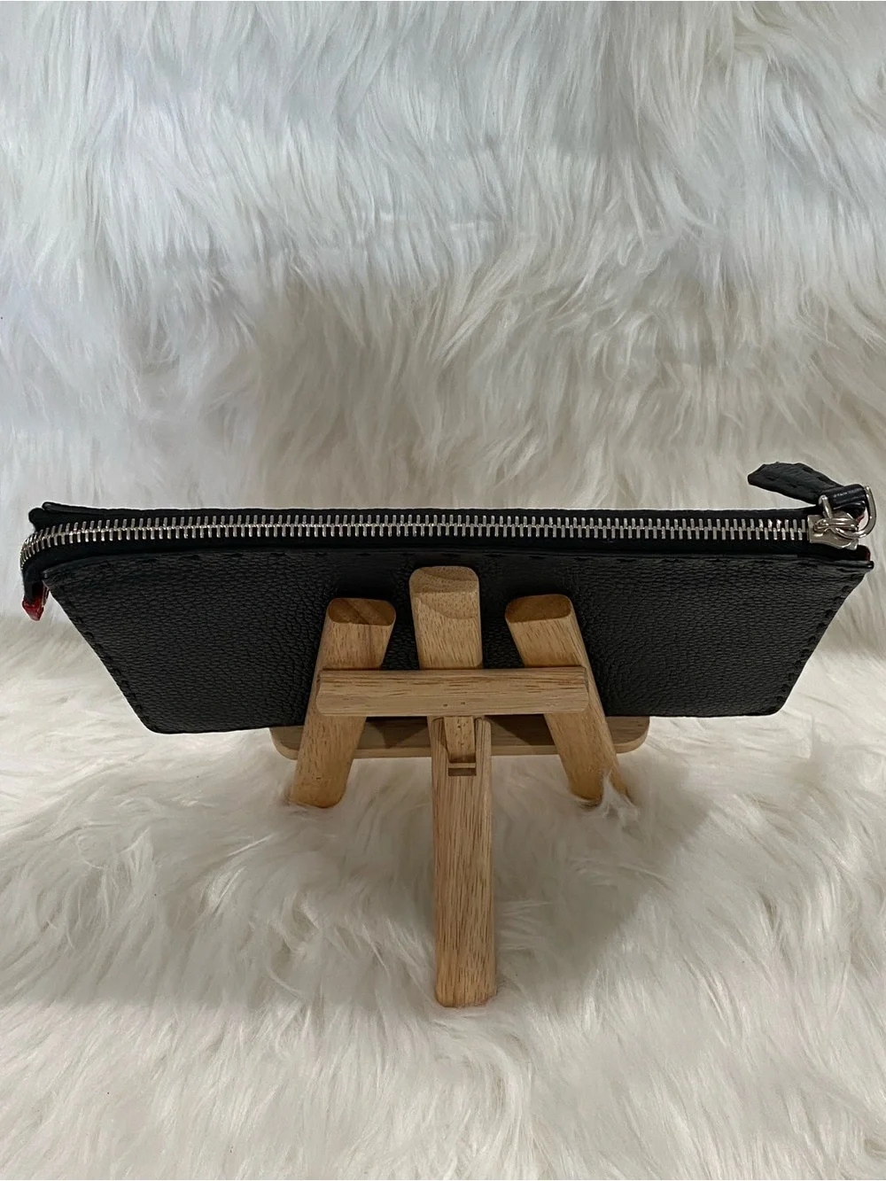 Fendi Selleria flat clutch bag with red stitching and red leather handle